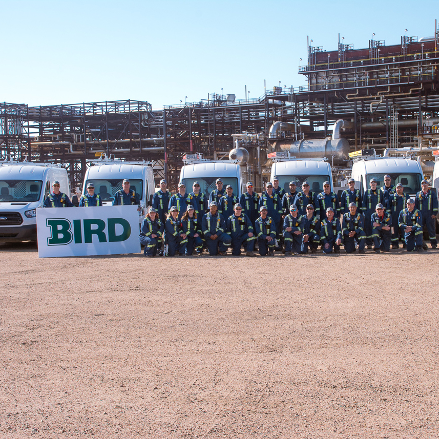 team of Bird site employees in front of industrial site