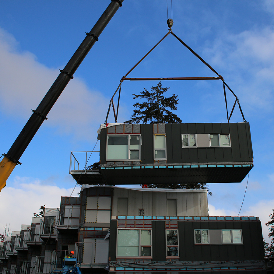 crane lifting modular unit into place