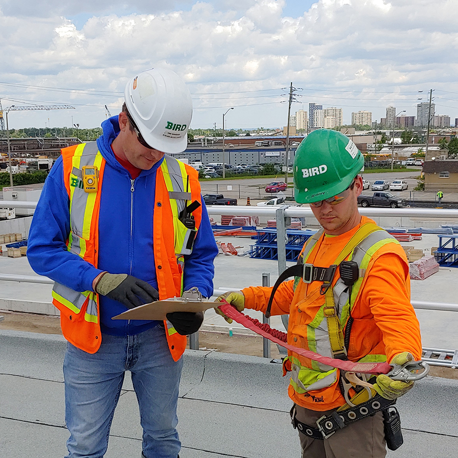Two construction workers with safety gear